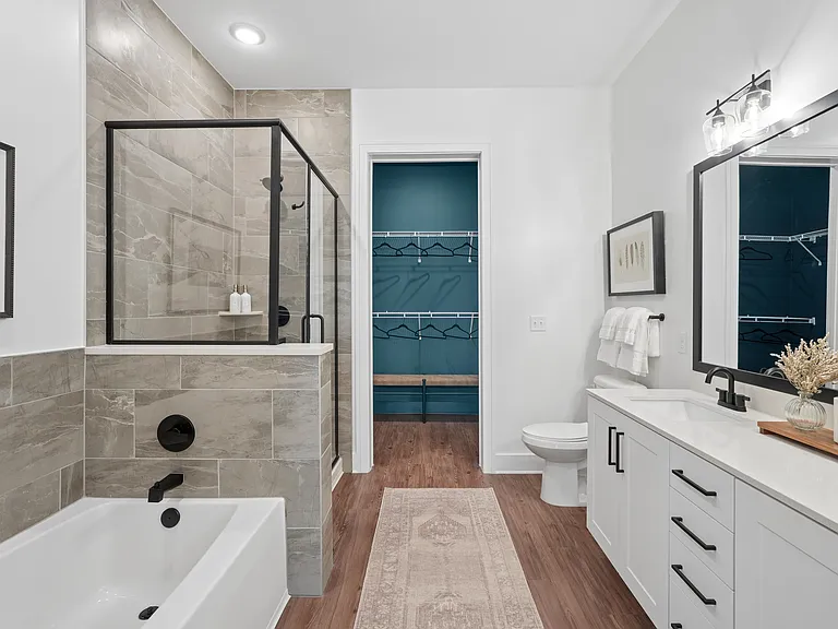 Bathroom with Quartz Countertops, Double Vanity Sinks, Walk-in Shower, and Soaking Tub