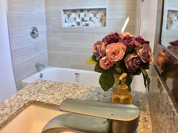 Bath with rain head shower