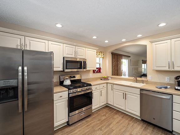 Eat in kitchen with stainless appliance, dishwasher and pass through to the dining area.