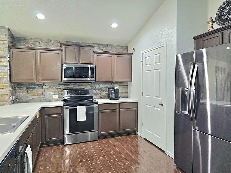 Kitchen: fully stocked with cooking essentials, spices, oil, pots, pans, dishware, eating and cooking utensils.