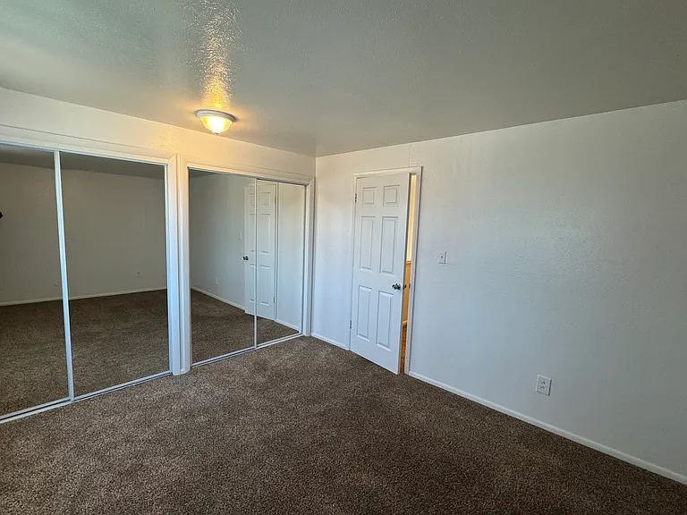 Master bedroom with 2 sets for mirror door closets.