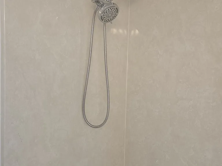Tub/shower combination with fixed and handheld shower heads.