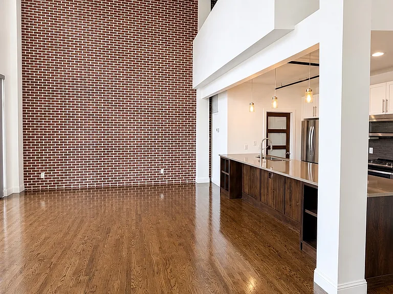 Living room with seamless flow to the kitchen and loft above.