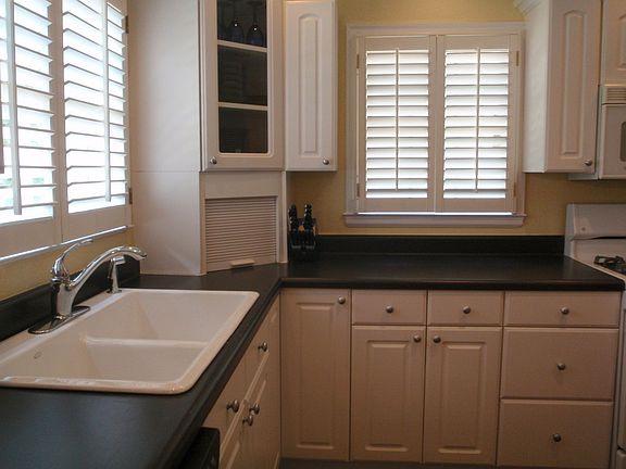 Kitchen w/ Plantation Shutters and Corian