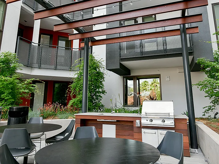 Outdoor kitchen with grilling station and dining areas