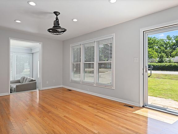 Open living room with a door leading right to the backyard.
