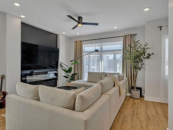 Dining/Living area. 86" TV with soundbar, subwoofer, and wall electric fireplace