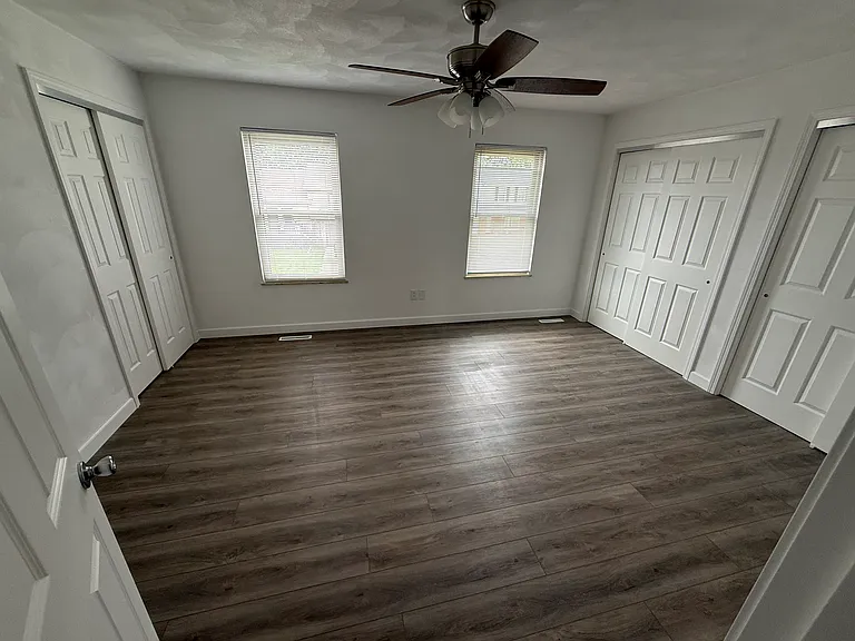Primary bedroom with his and hers closets.