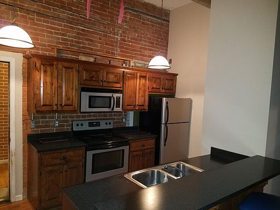 Kitchen with granite counters, dishwasher, microwave,
