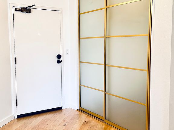 Entry door, lobby, and coat/storage closet