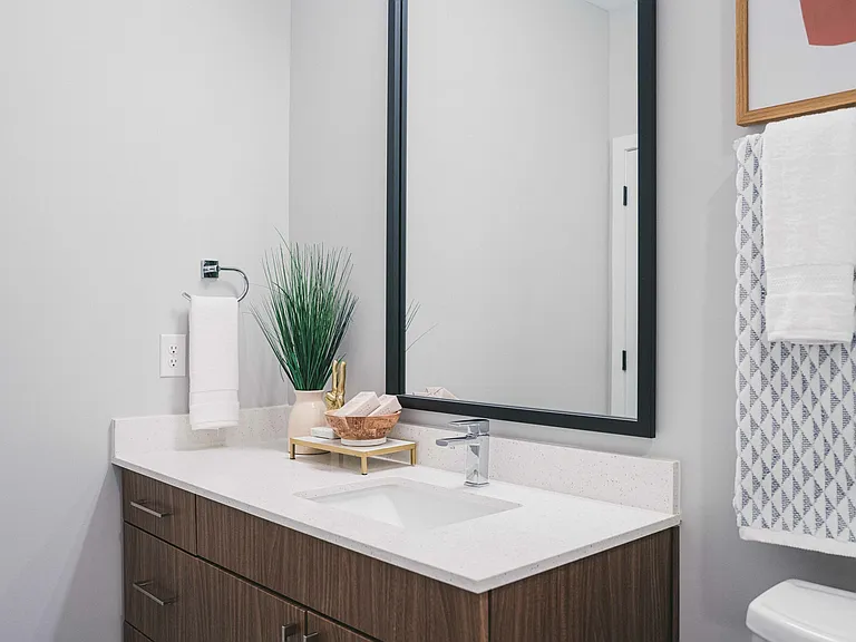 Modera Germantown features chic bathrooms with elegant framed mirrors.
