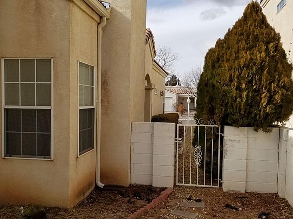 Back yard view toward the street. This house nests between two story houses