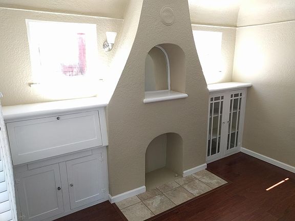 Living room built in desk, faux fireplace and cabinets