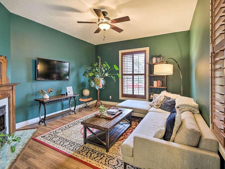 Living room with plantation shutters for added privacy and making the room nice and dark for watching movies. TV stays if you would like it.