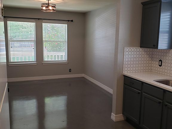 Polished concrete floors, quartz countertops, backsplash in kitchen Refrigerator and dishwasher included.