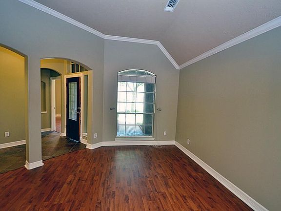 A view of the formal living area and the foyer. Area has beautiful wood laminate floors and crown mo