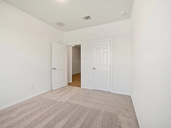An additional view of the second bedroom and closet