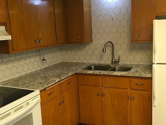 Quaint kitchen with vintage cabinets and new granite tops and backsplash