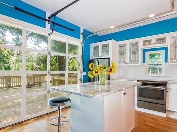 All glass large door in the kitchen opens to the deck.