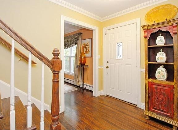 Inviting foyer leads to living room and dining area in eat-in kitchen.