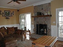 Family room with stone firplace, french doors to screened room.