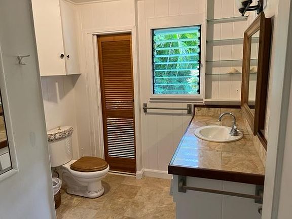 Bath room with marble counter top and floors