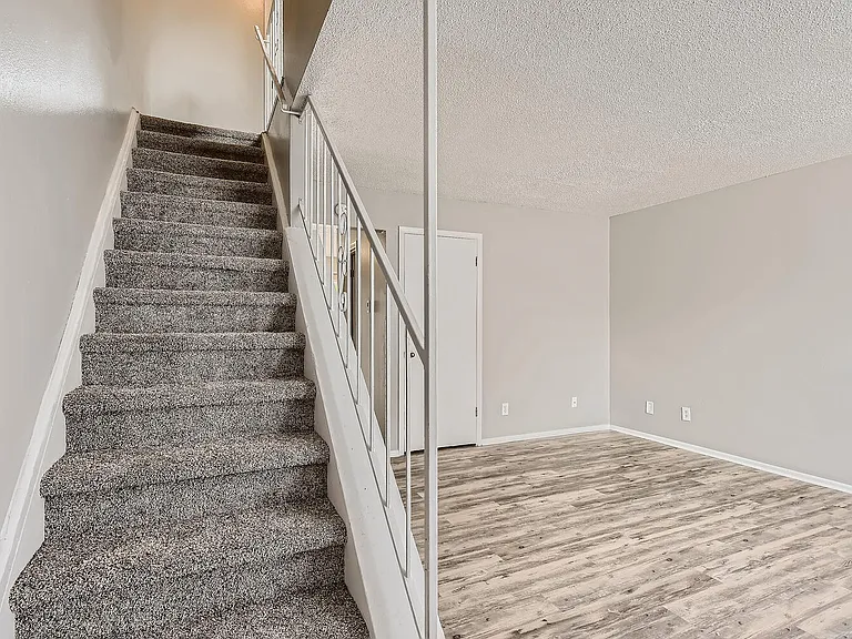 A living Room and staircase at Alder Square Rental Townhomes