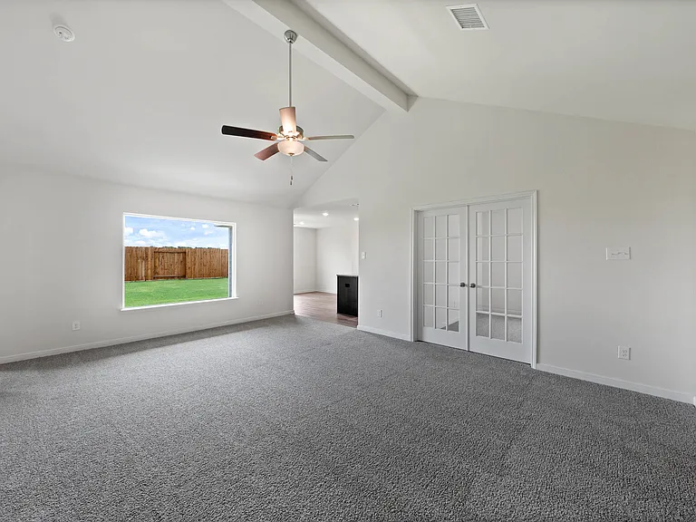 The spacious family room has a large window with great natural light and backyard views.