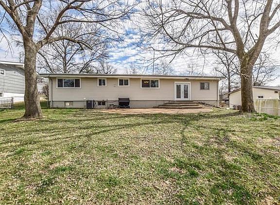 Back of house with great level fenced back yard!