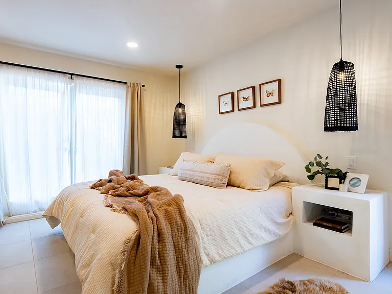 Primary ensuite (king bed with built in nightstands, French doors opening up outside)