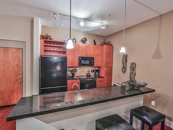 Contemporary dining space seamlessly connected to the kitchen and living room. The open-concept design enhances the sense of space, while modern lighting and finishes make this area ideal for both casual dining and entertaining guests.
