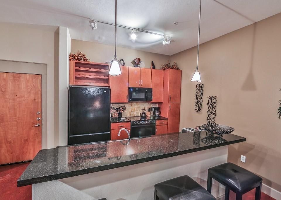 Contemporary dining space seamlessly connected to the kitchen and living room. The open-concept design enhances the sense of space, while modern lighting and finishes make this area ideal for both casual dining and entertaining guests.