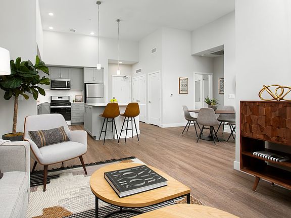 Apartments with hard surface flooring in kitchen, living, and dining areas