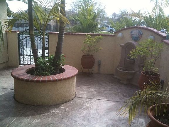 Courtyard with stamped concrete, planter, fountain and lighting