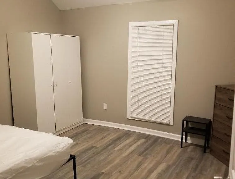 Bedroom with wardrobe or closet fullsize bed, dresser, end table