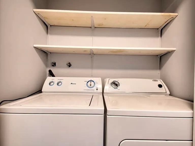 Washer and dryer behind doors included in the unit.