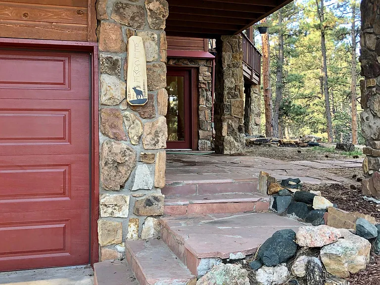 Main entrance is to the right of the garage