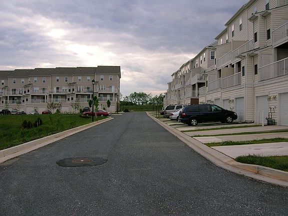 Ground level view of rear drive behind property
