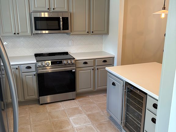 Kitchen view from entry - shows wine fridge and peninsula breakfast bar