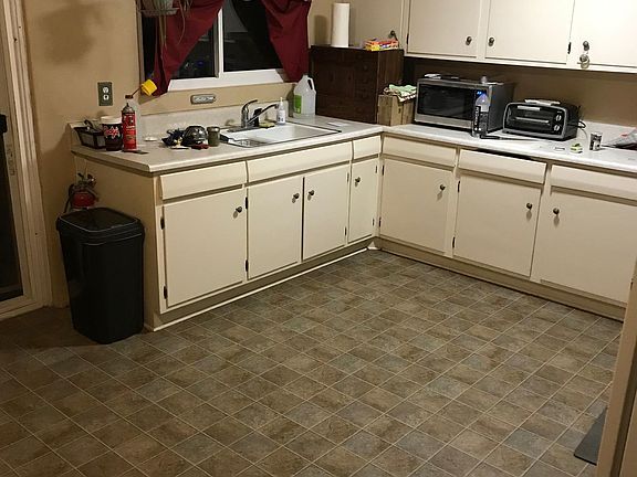 Open kitchen with Gas Range, Large Refrigerator, extensive storage and overhead fan.