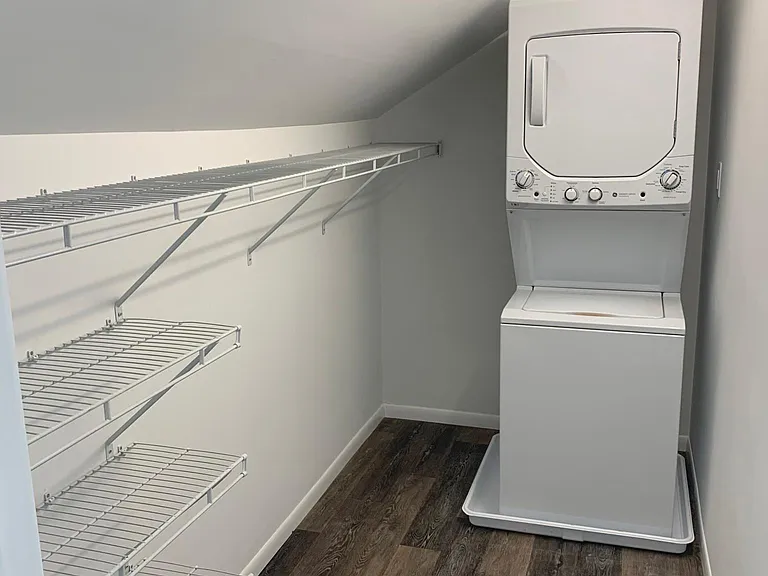 Main bedroom walk-in closet with washer and dryer