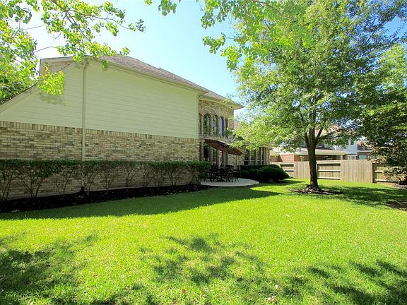 A lush lawn fills the back yard.