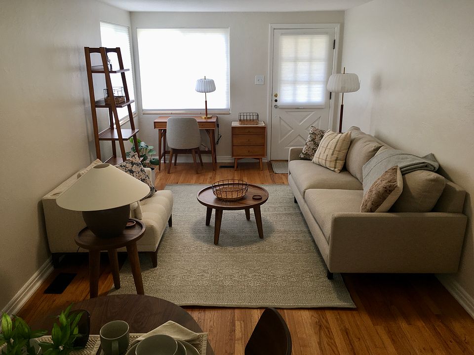 Living room with a mid-century modern look and all new furniture. Blinds are new and the walls, trim and ceiling are freshly painted. New light fixtures and large closet.