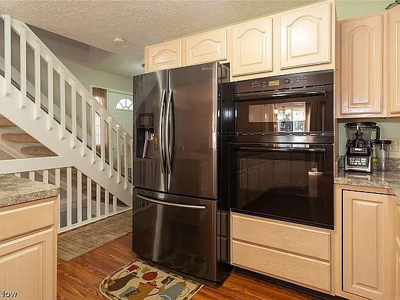 Kitchen Fridge, Microwave & Oven. View facing front door and stairs