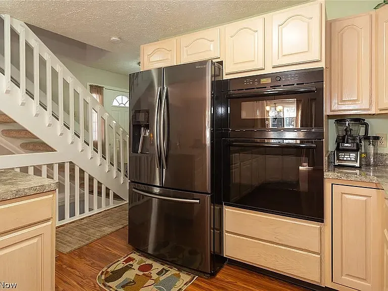 Kitchen Fridge, Microwave & Oven. View facing front door and stairs