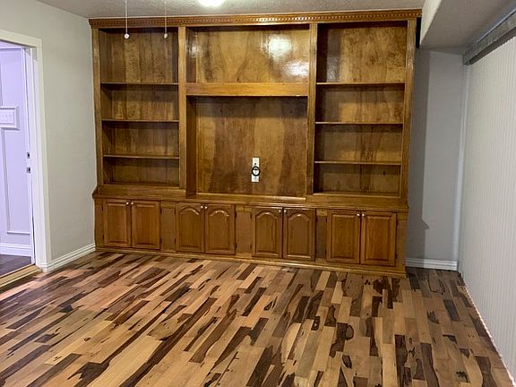 Family Den with wood flooring.