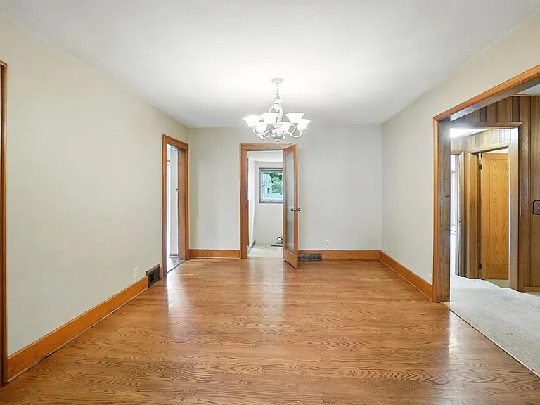 Dining Room looking into laundry Room. To the left is the entrance to kitchen and to the right are entrances to family room and sunroom.