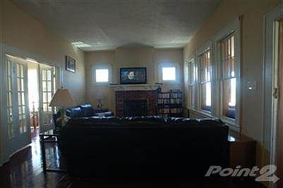 In addition to the large living room, the front porch is enclosed all the way across the front of the home.