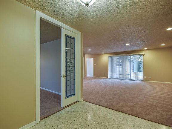 Elegant foyer with french doors into dining and open to living room.