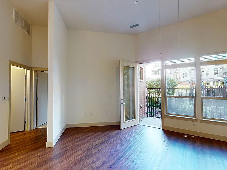Apartment living room with wood-style flooring.